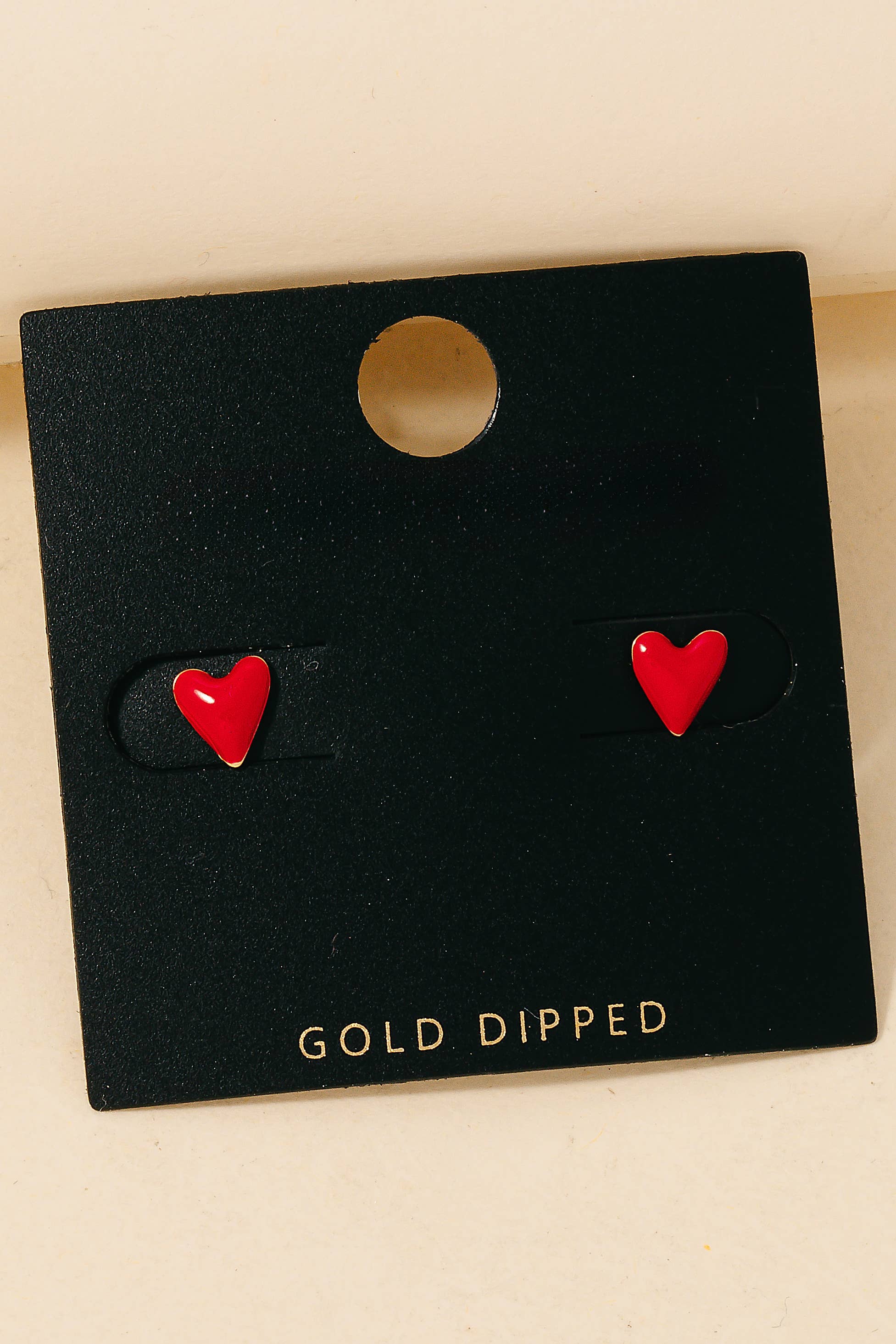 Gold dipped red epoxy heart stud earrings for a bold look