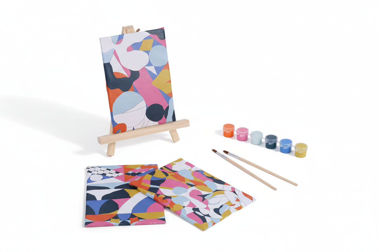 Colorful abstract art set with canvases, paintbrushes, and paint containers on a white background