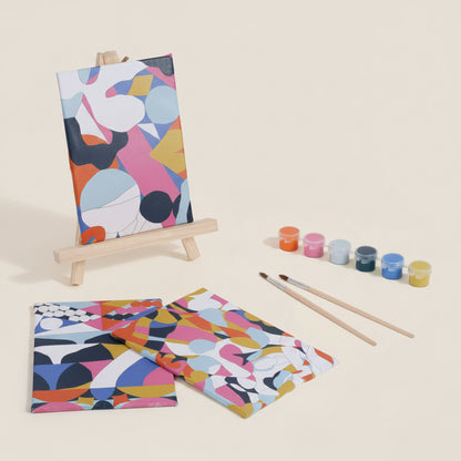 Colorful abstract art set with canvases, paintbrushes, and paint containers on a white background