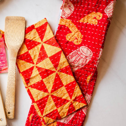 Wooden utensils and colorful fabric with geometric patterns on a light background