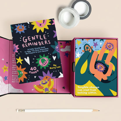 Colorful card deck with 'Gentle Reminders' and 'Daily Oracle Deck' text, featuring abstract designs.