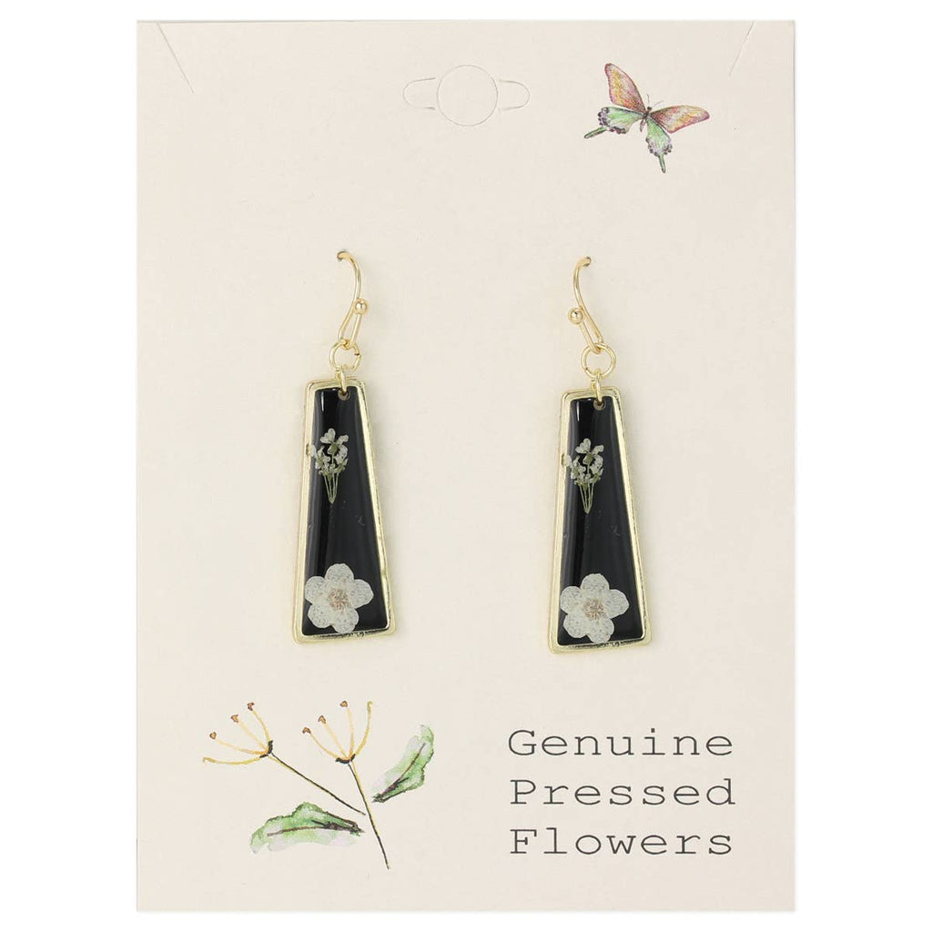 Black teardrop earrings with floral details on a beige card with botanical illustrations.