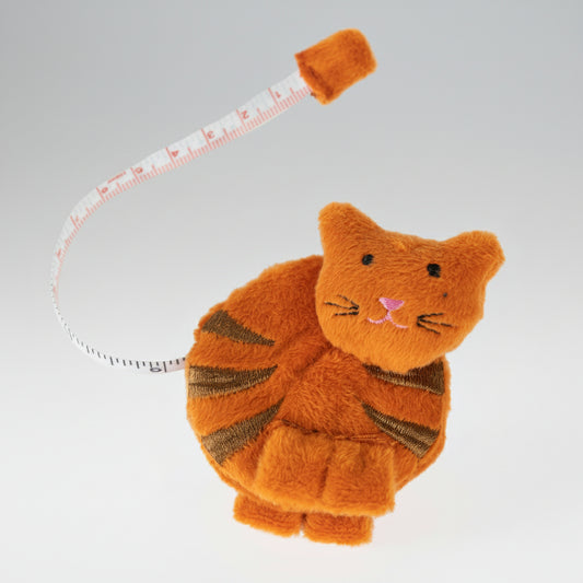 An orange fabric cat tape measurer on a white background