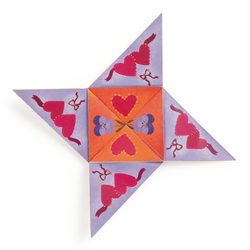 Decorative paper fortune teller with heart and flower patterns on a white background