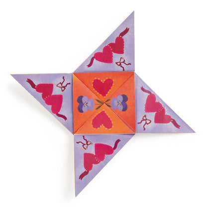 Decorative paper fortune teller with heart and flower patterns on a white background
