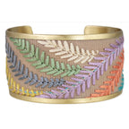 Wide gold bracelet with colorful embroidered leaves on a white background