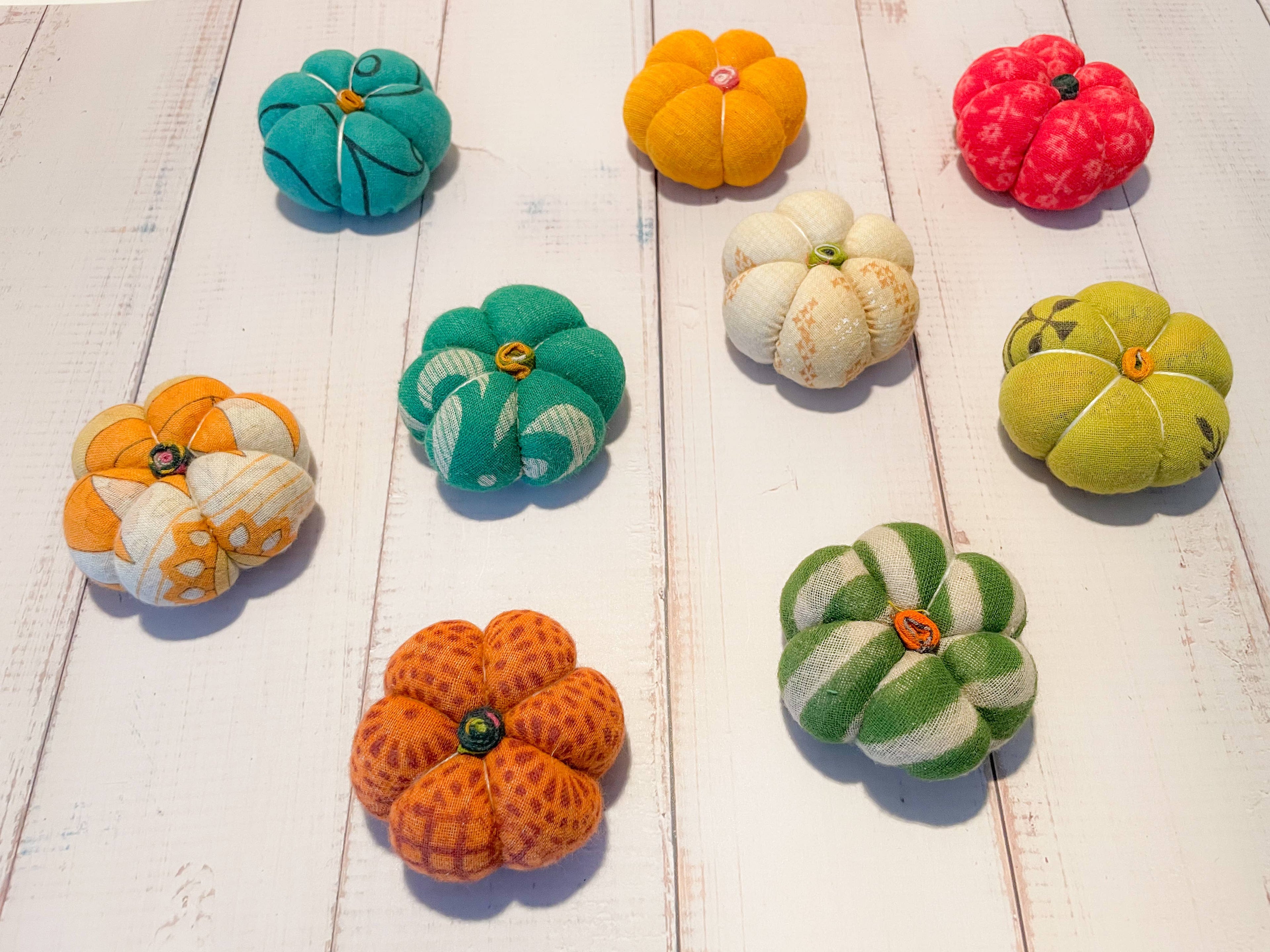 Group of 9 mini pumpkins made from vibrant recycled sari fabric in assorted autumn hues