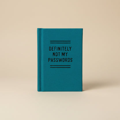 Mini teal notebook with 'DEFINITELY NOT MY PASSWORDS' text on a white background