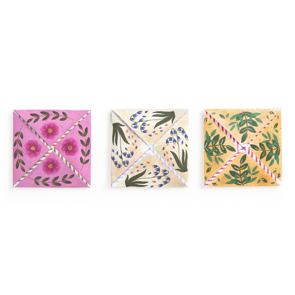 Three square coasters with floral designs on a white background