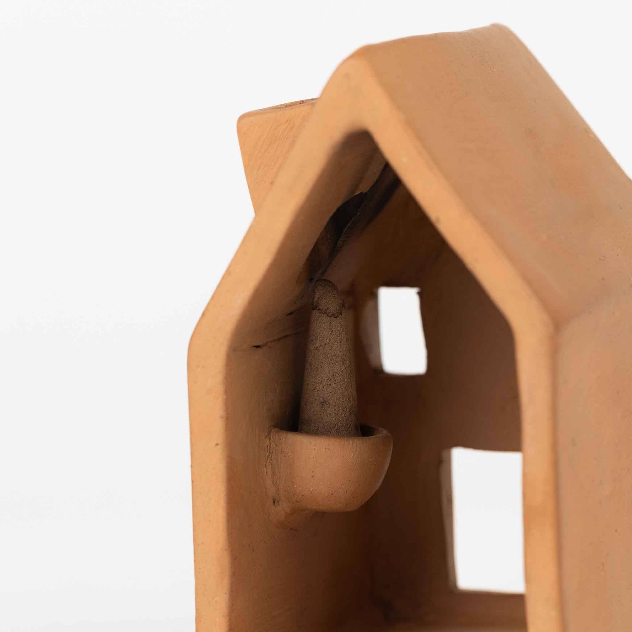 Detailed view of where the cone of incense sits on the back of the incense holder 