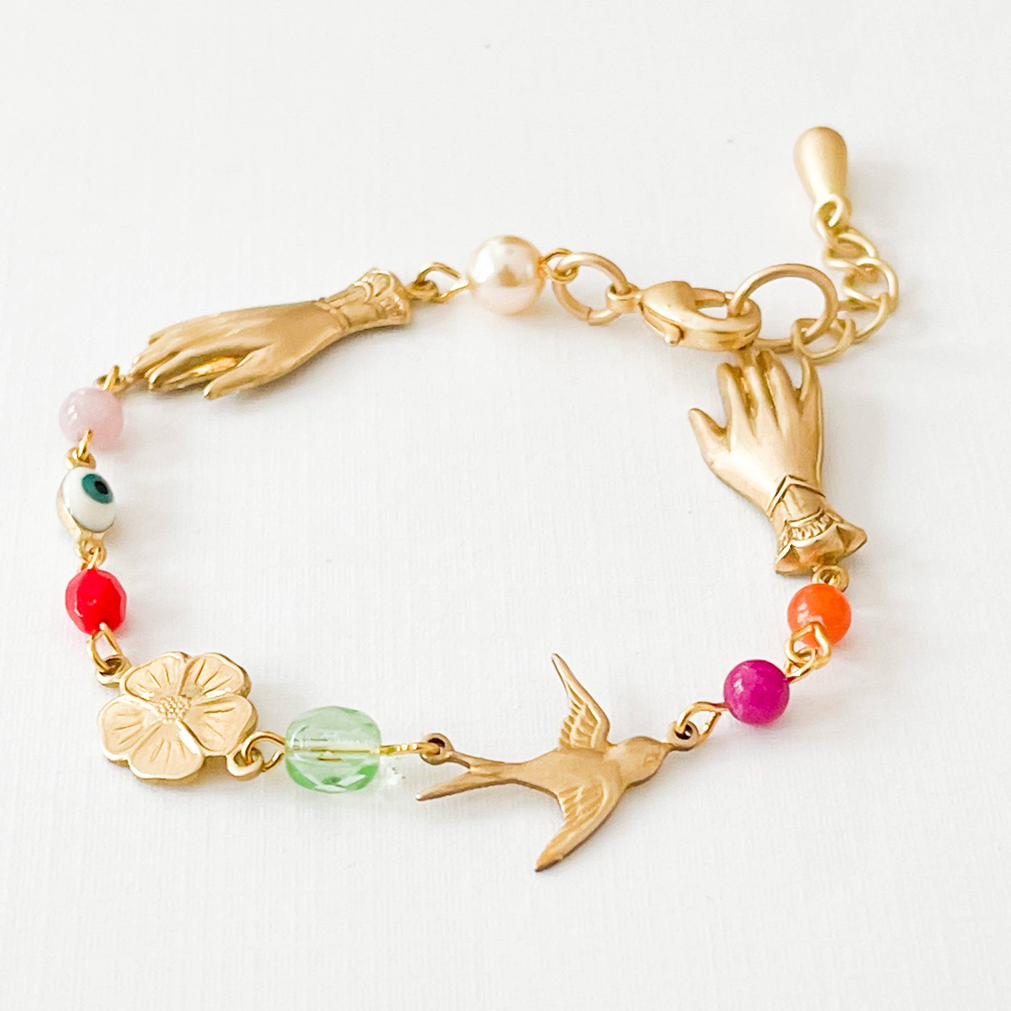 Detail of beaded evil eye bracelet with lobster clasp and gold charms