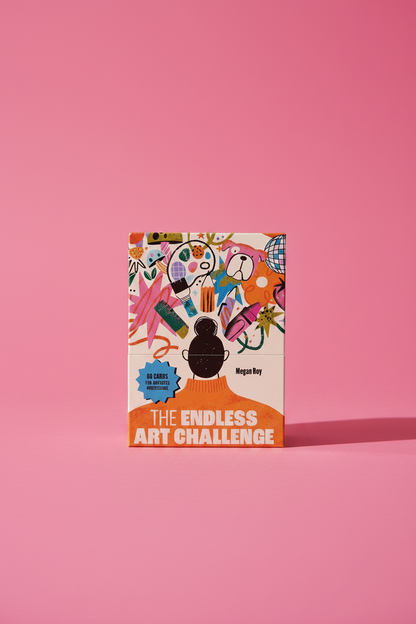 Box for 'The Endless Art Challenge' with colorful design displayed on a light beige tabletop.
