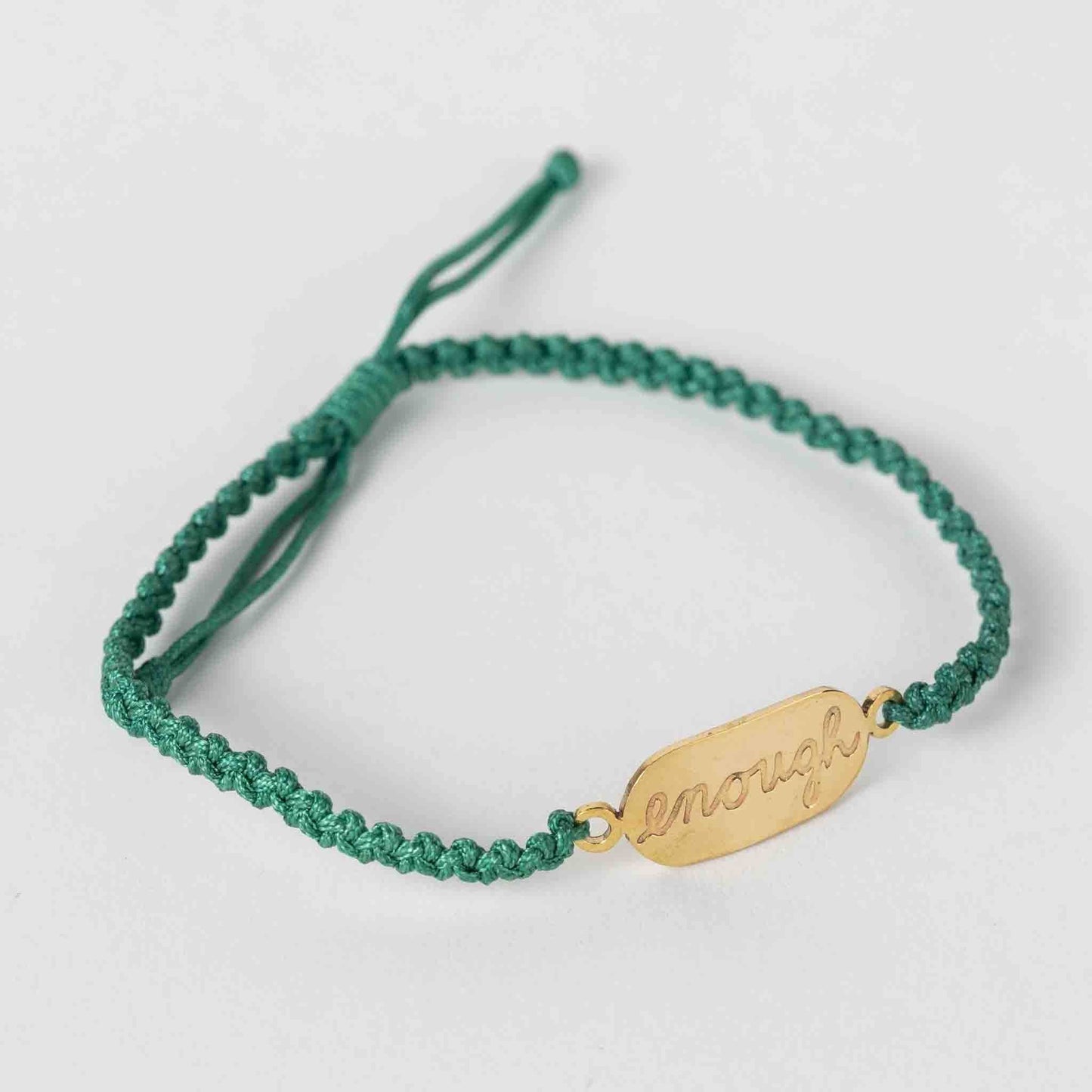 Empowering macrame bracelet with "You Are Enough" message, displayed on neutral background