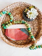 Decorative wreath with beads and succulent on a woven mat showcasing one of the bags