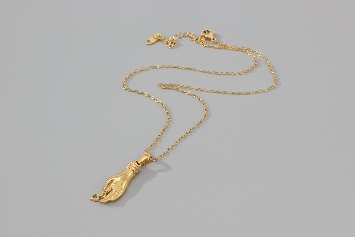 Gold necklace with a pendant on a white background