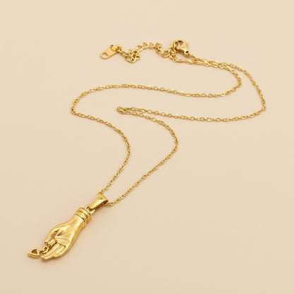 Gold necklace with a pendant on a white background