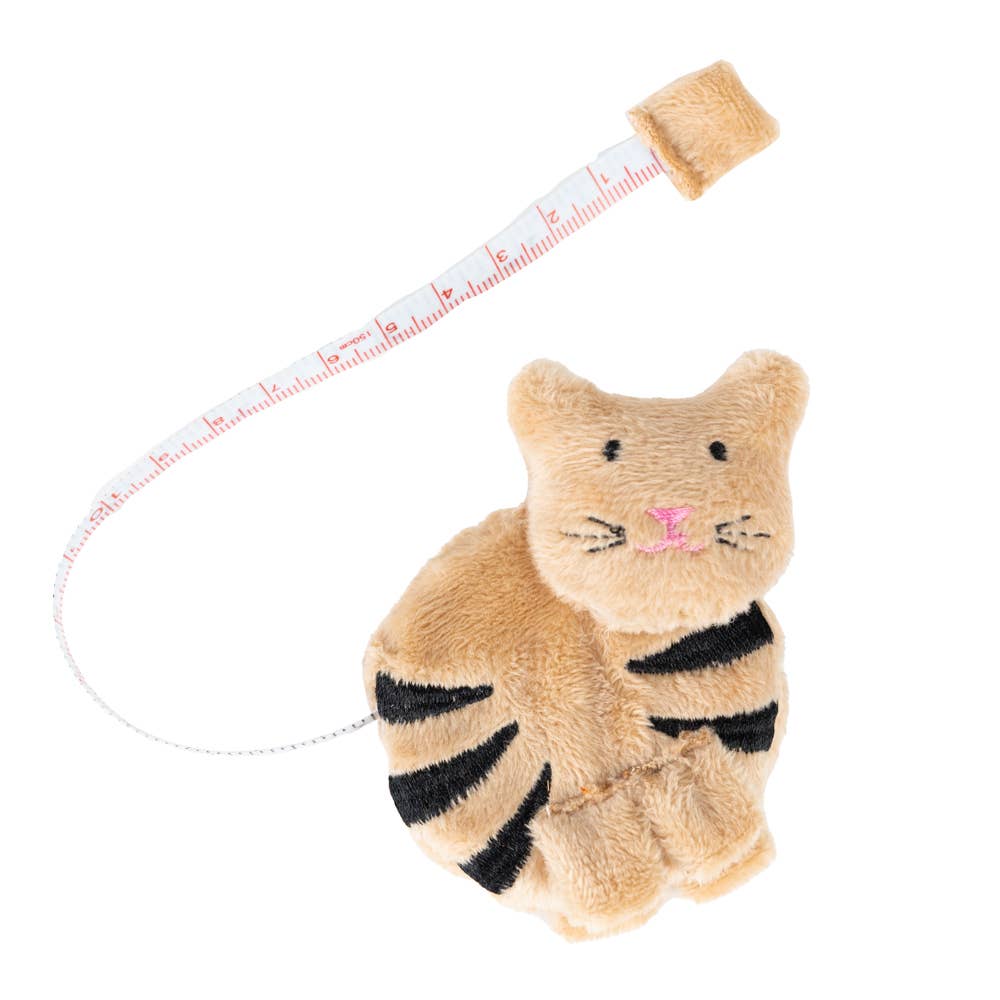 A beige fabric cat tape measurer on a white background