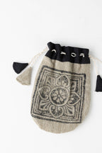 Close-up view of a handcrafted gift bag showing textured cotton weave