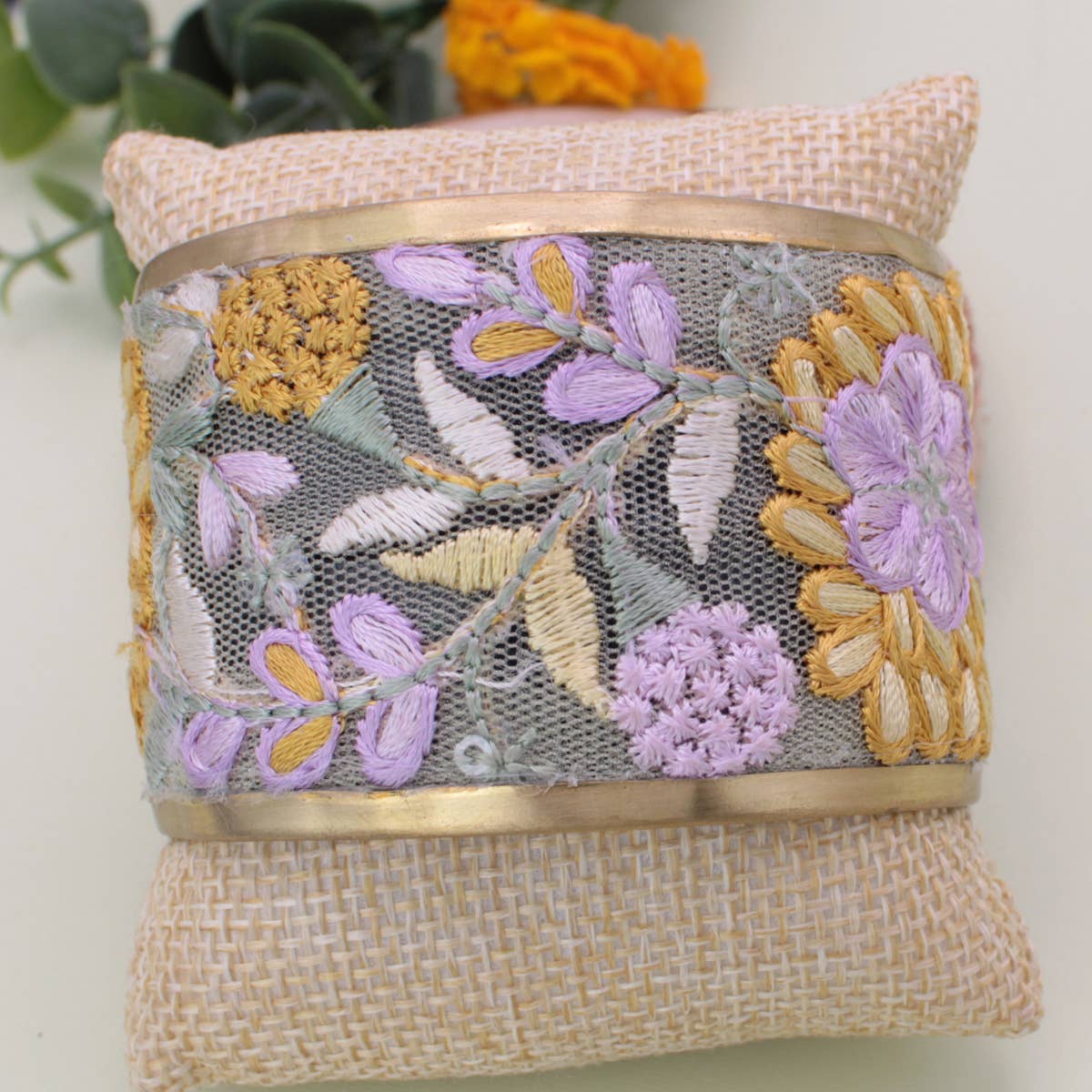 Handmade clutch with floral embroidery and woven texture