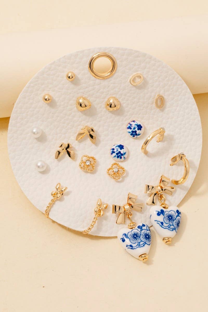Assorted pearl, ribbon, and ceramic stud earrings on display card