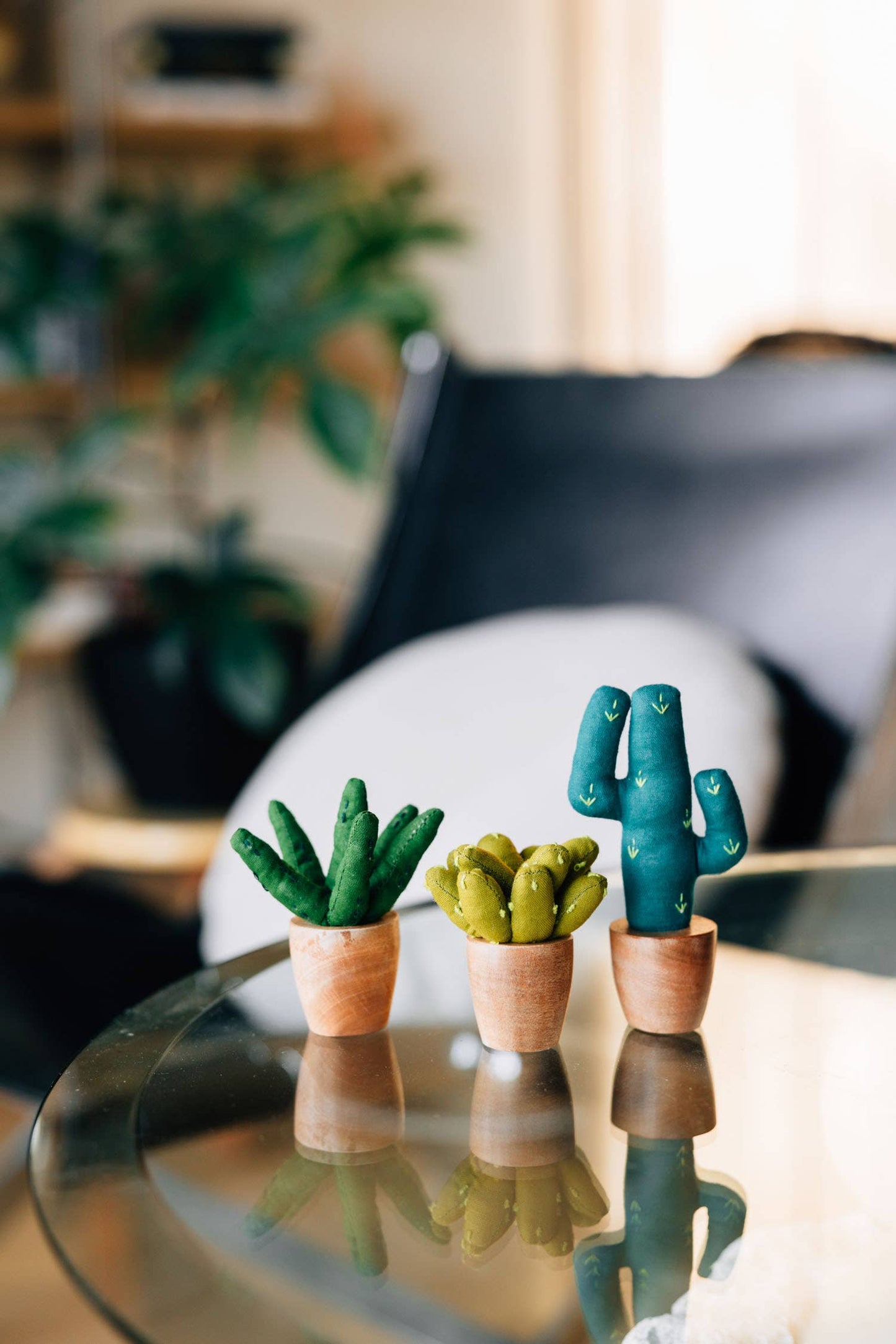 Mini cotton aloe vera plush in a terracotta-toned base, placed on a desk