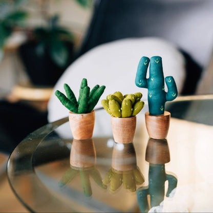 Mini cotton aloe vera plush in a terracotta-toned base, placed on a desk