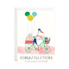 Illustrated stork riding a bicycle with balloons and a basket