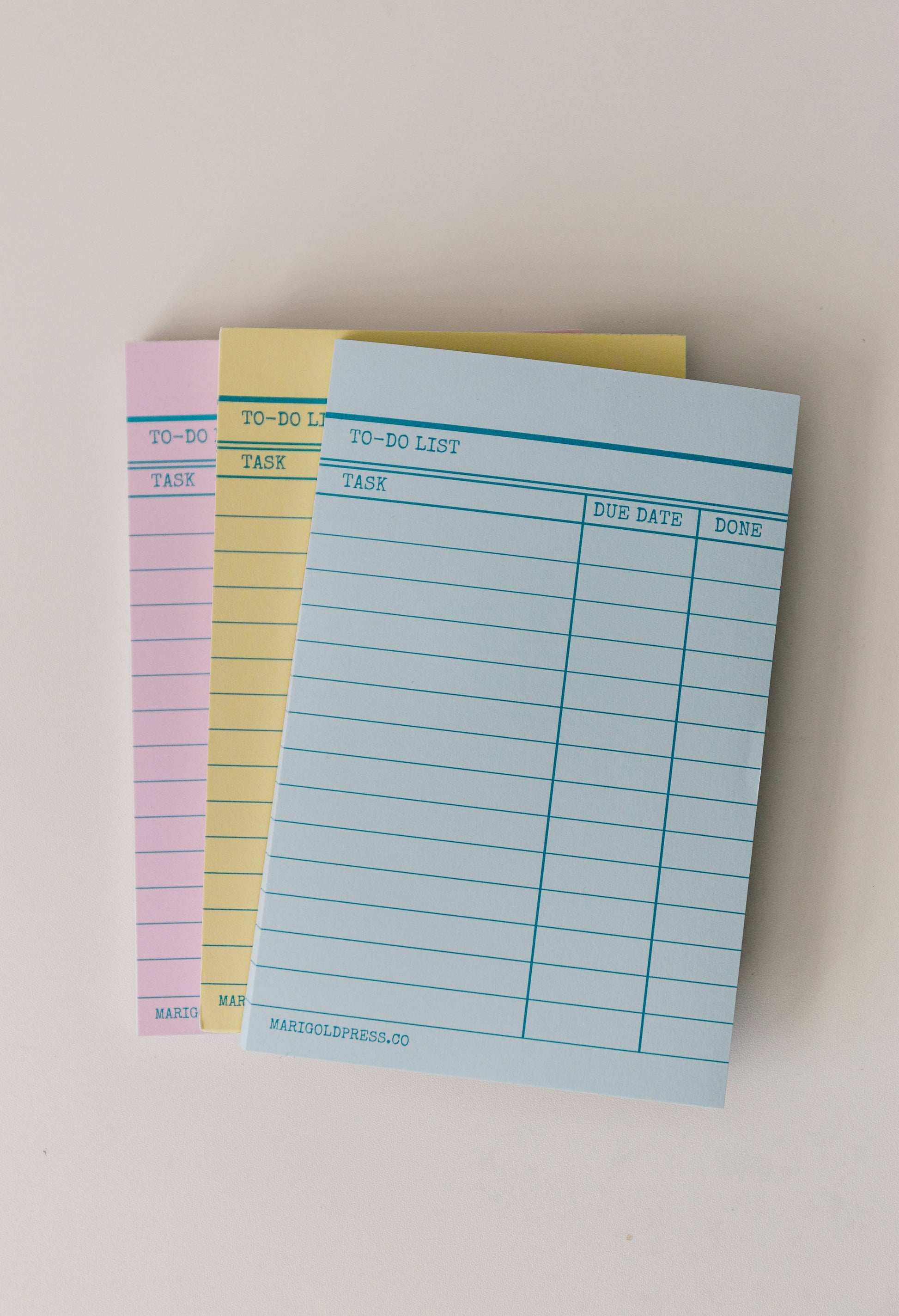 Stack blue, yellow, and pink vintage library notepad showcasing their fun and functionality