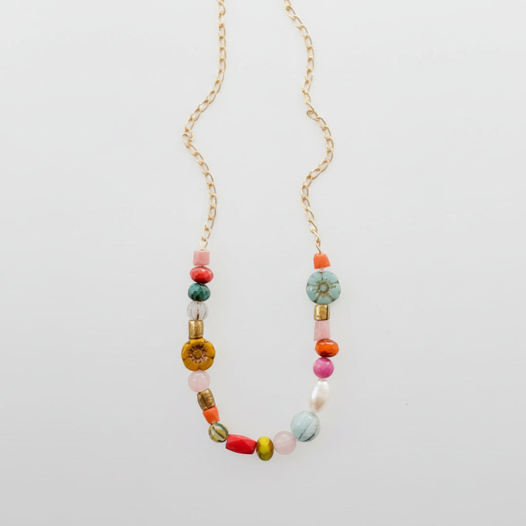 Delicate handmade necklace with pearl, flower, and turquoise bead detail