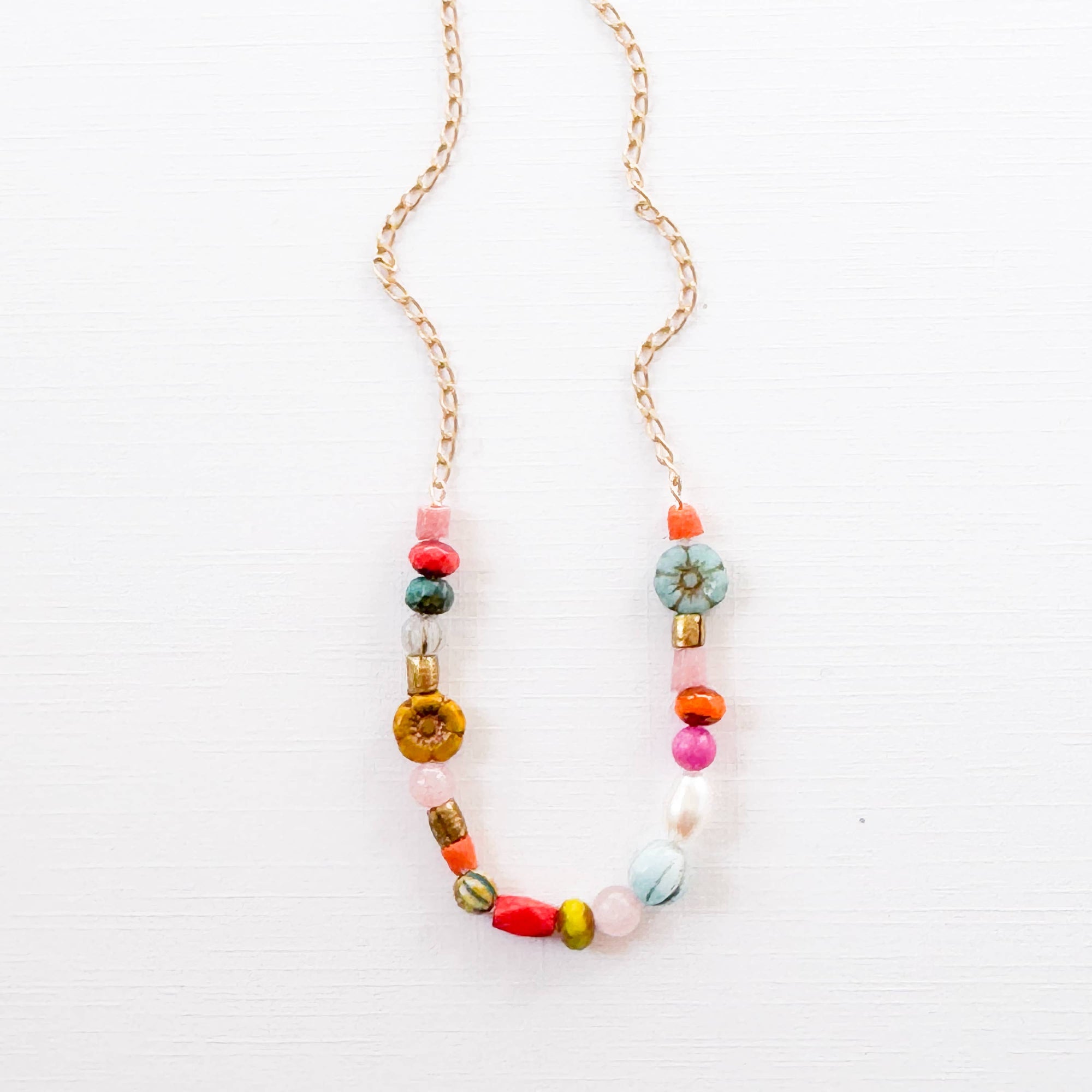 Delicate handmade necklace with pearl, flower, and turquoise bead detail