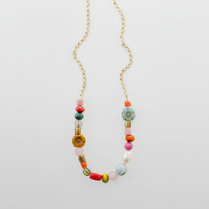 Delicate handmade necklace with pearl, flower, and turquoise bead detail
