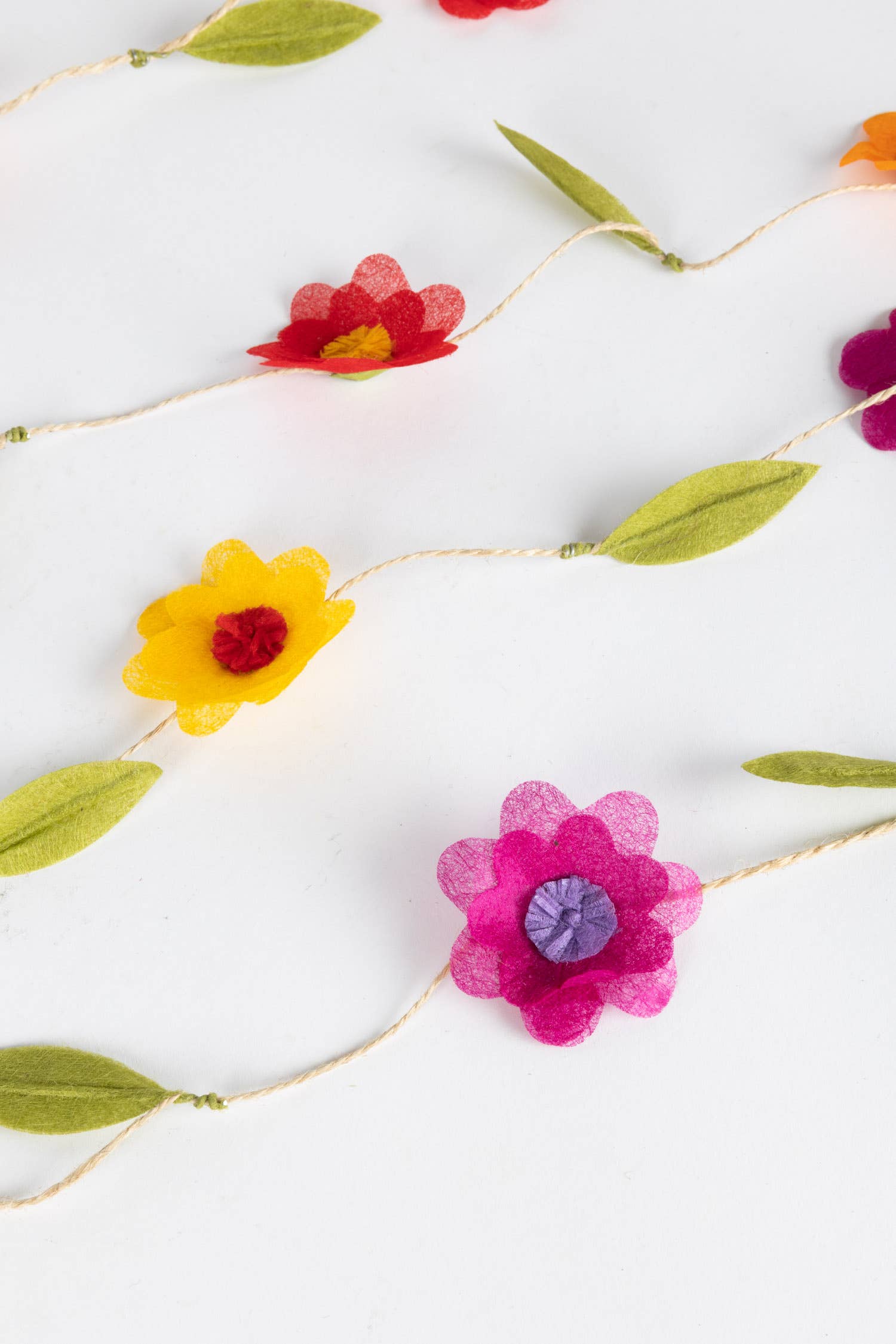 Close-up of silk paper flowers with moldable leaves on a 12-foot twine garland