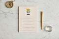 A to-do list notepad with a cartoon queen illustration at the top and lined spaces for writing on the bottom, on a beige background.
