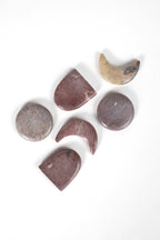 Set of stone-shaped coasters on a white background