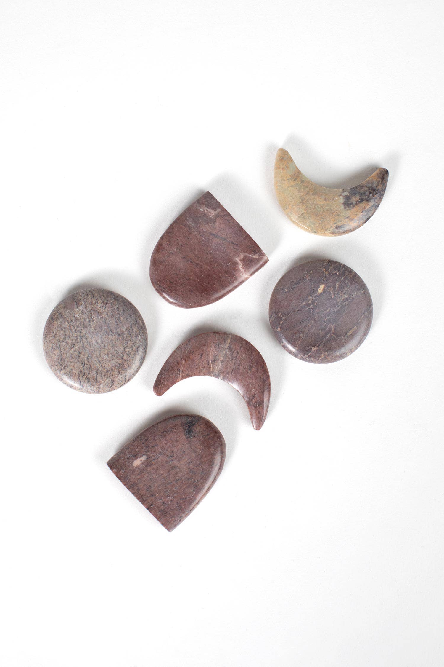 Set of stone-shaped coasters on a white background