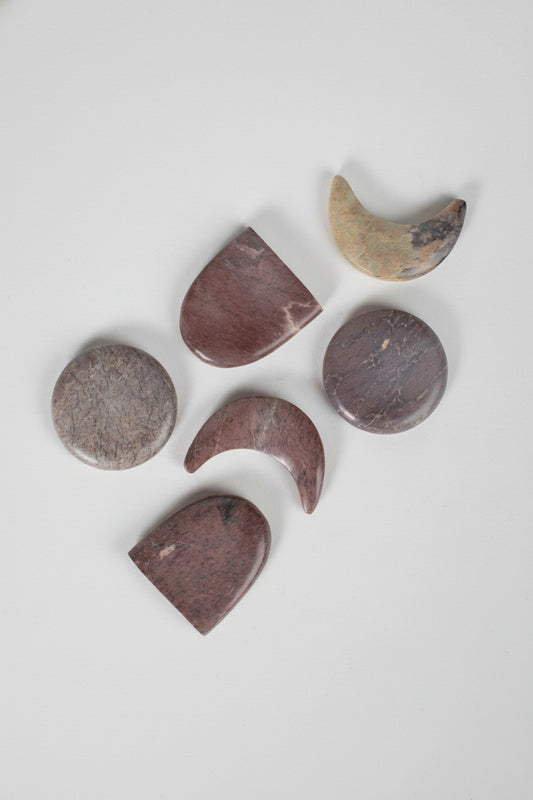 Set of stone-shaped coasters on a white background