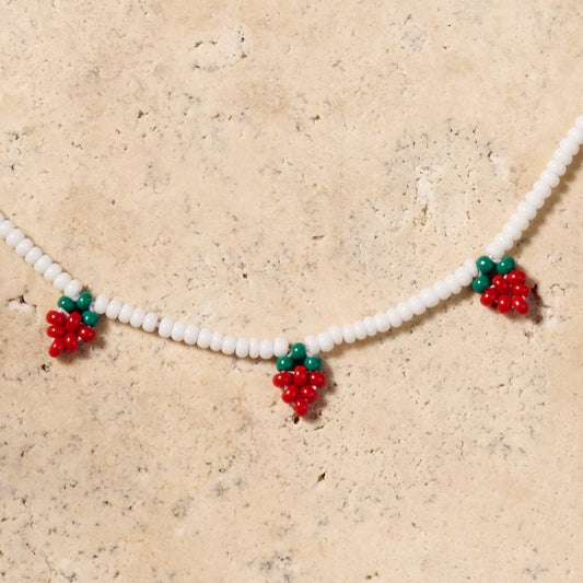 
Adjustable strawberry necklace with bright beadwork, glowing white beads on soft cotton string