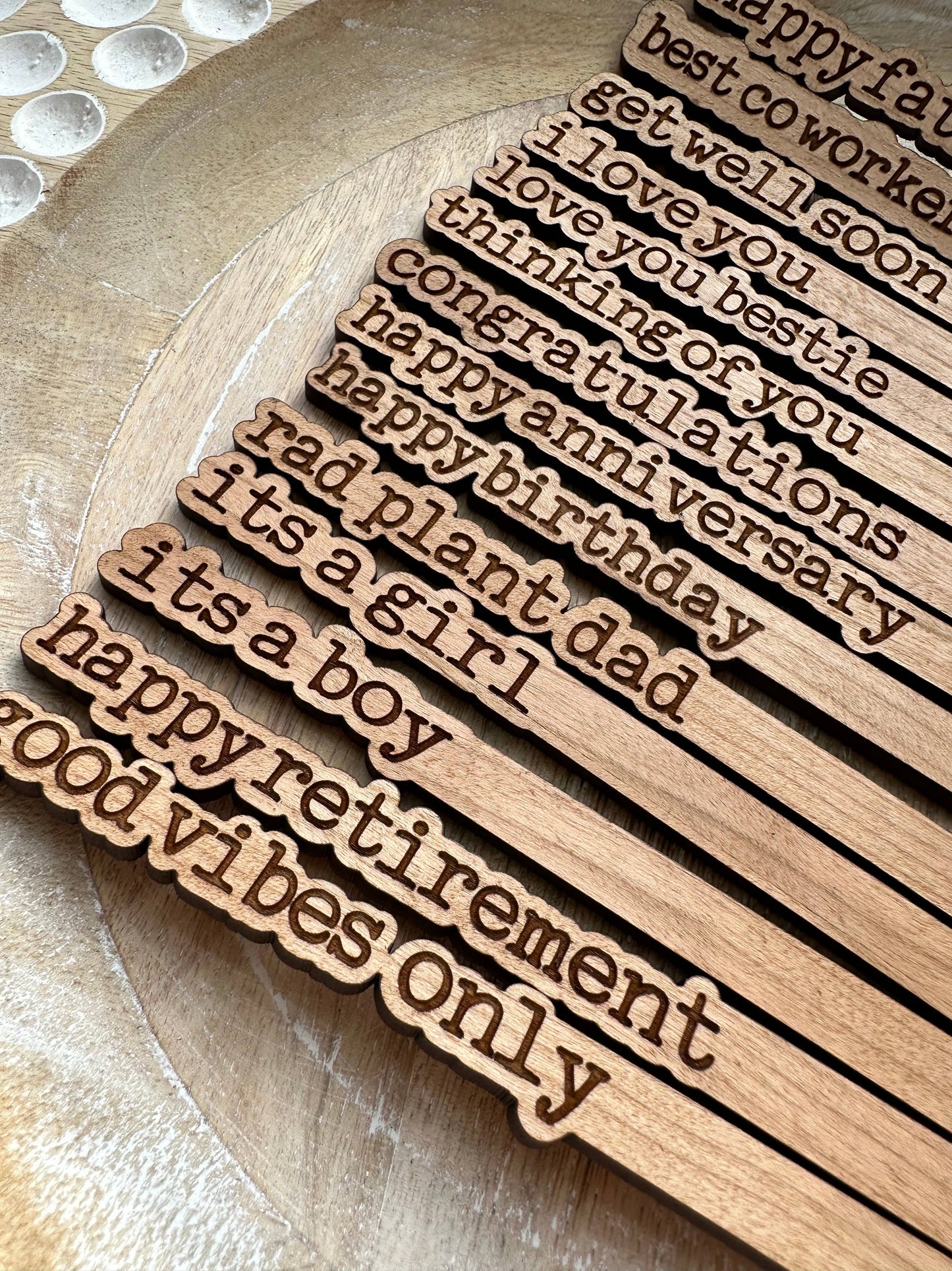 Laser-engraved plant sticks sealed for durability, ready for gifting.