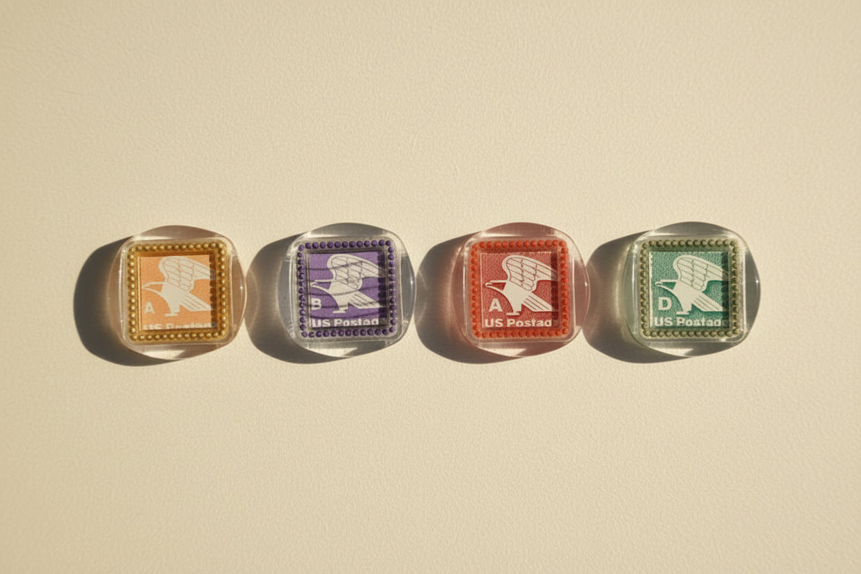 Four vintage postage stamp magnets created by Rochambeau Home on a white background.