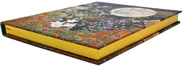Close-up of embossed floral detail and shimmering gilded page edges