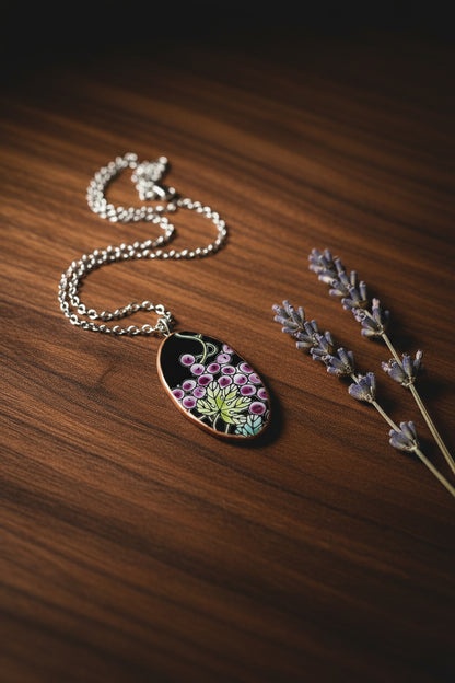 Necklace with an oval pendant featuring a grape design on a white background