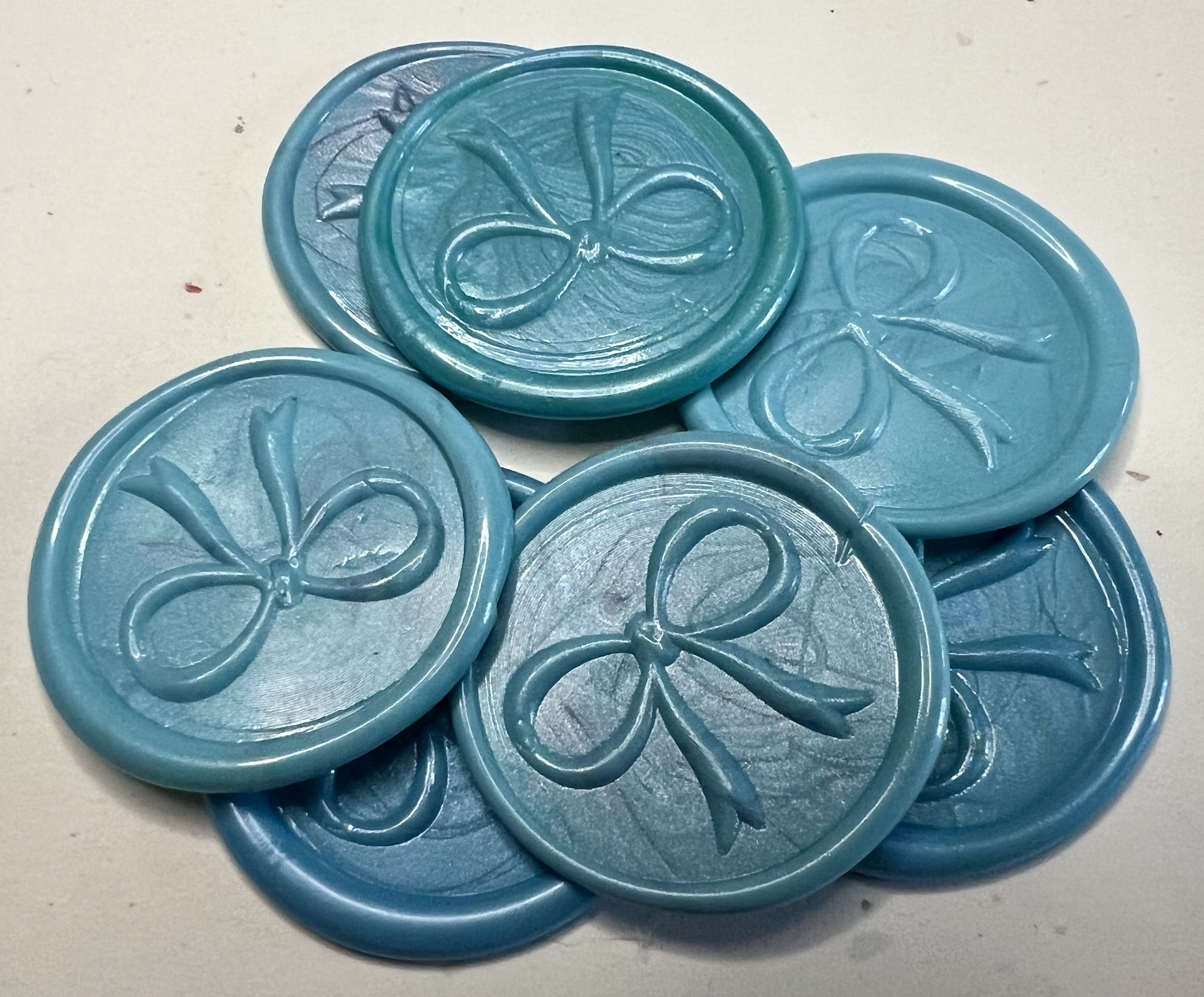 Elegant blue bow wax seal tags for gift wrapping, offering sophistication and charm for every occasion.

