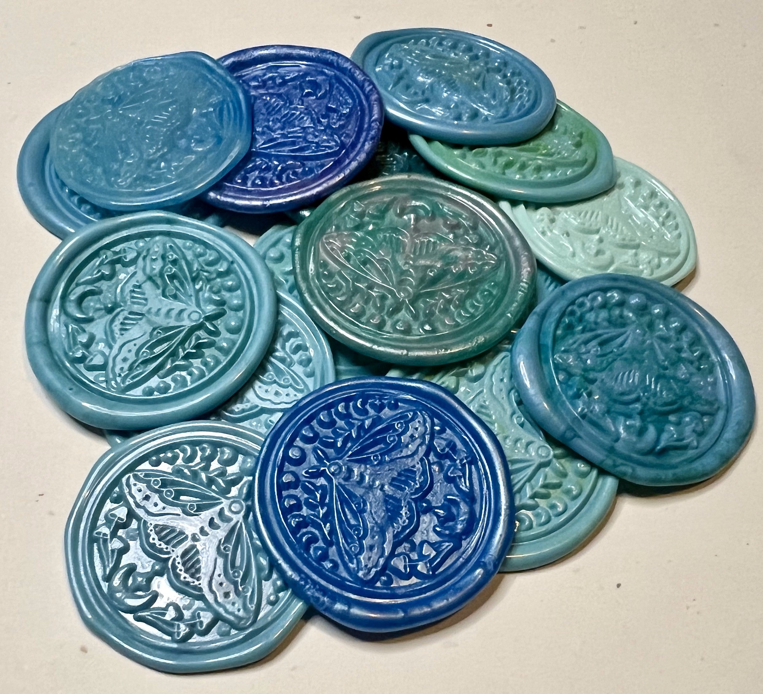 Blue wax seal sticker with a stargazing moth motif, ideal for celestial-themed events