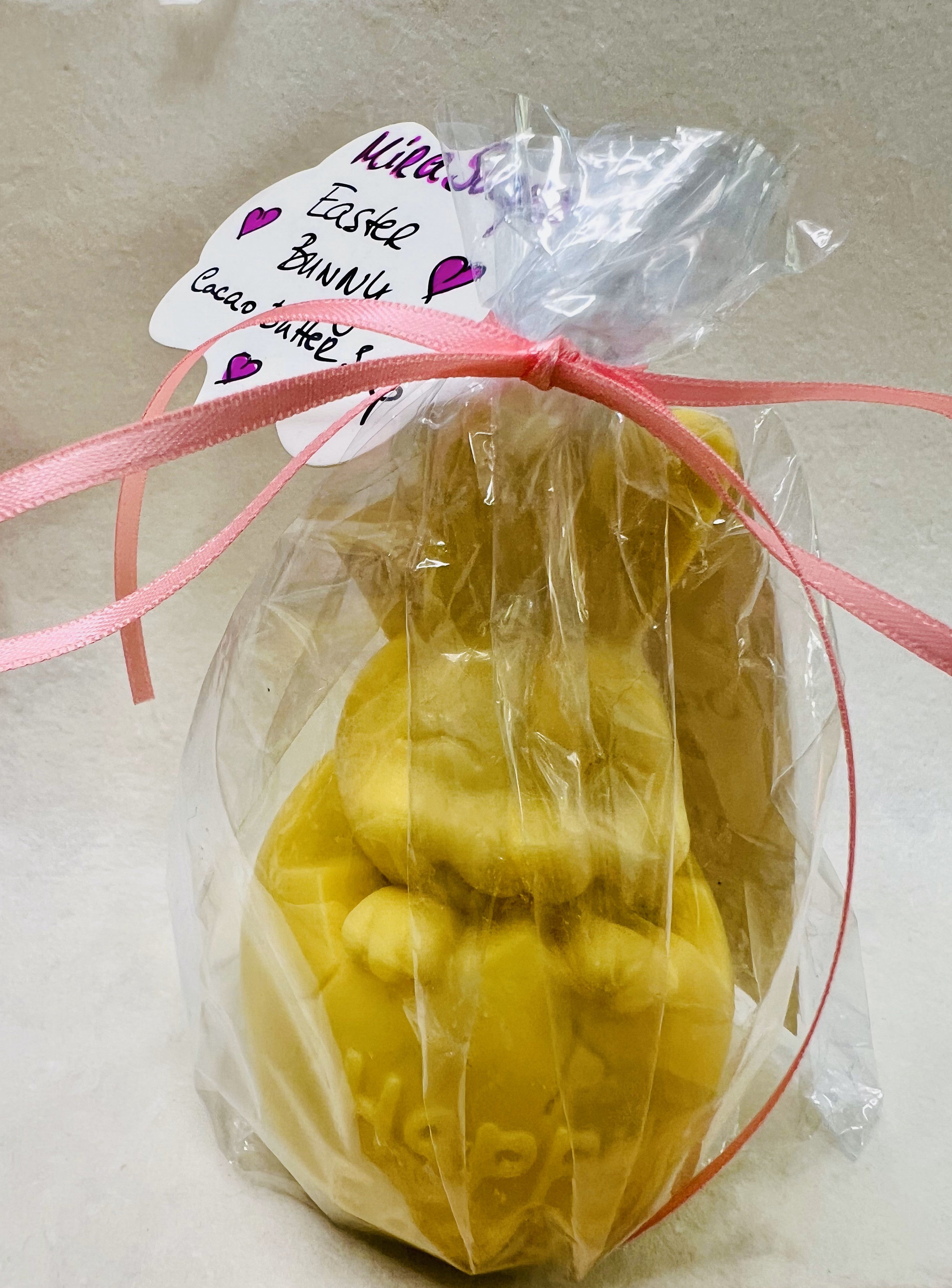 Vanilla-scented bunny soap resting beside spring blossoms