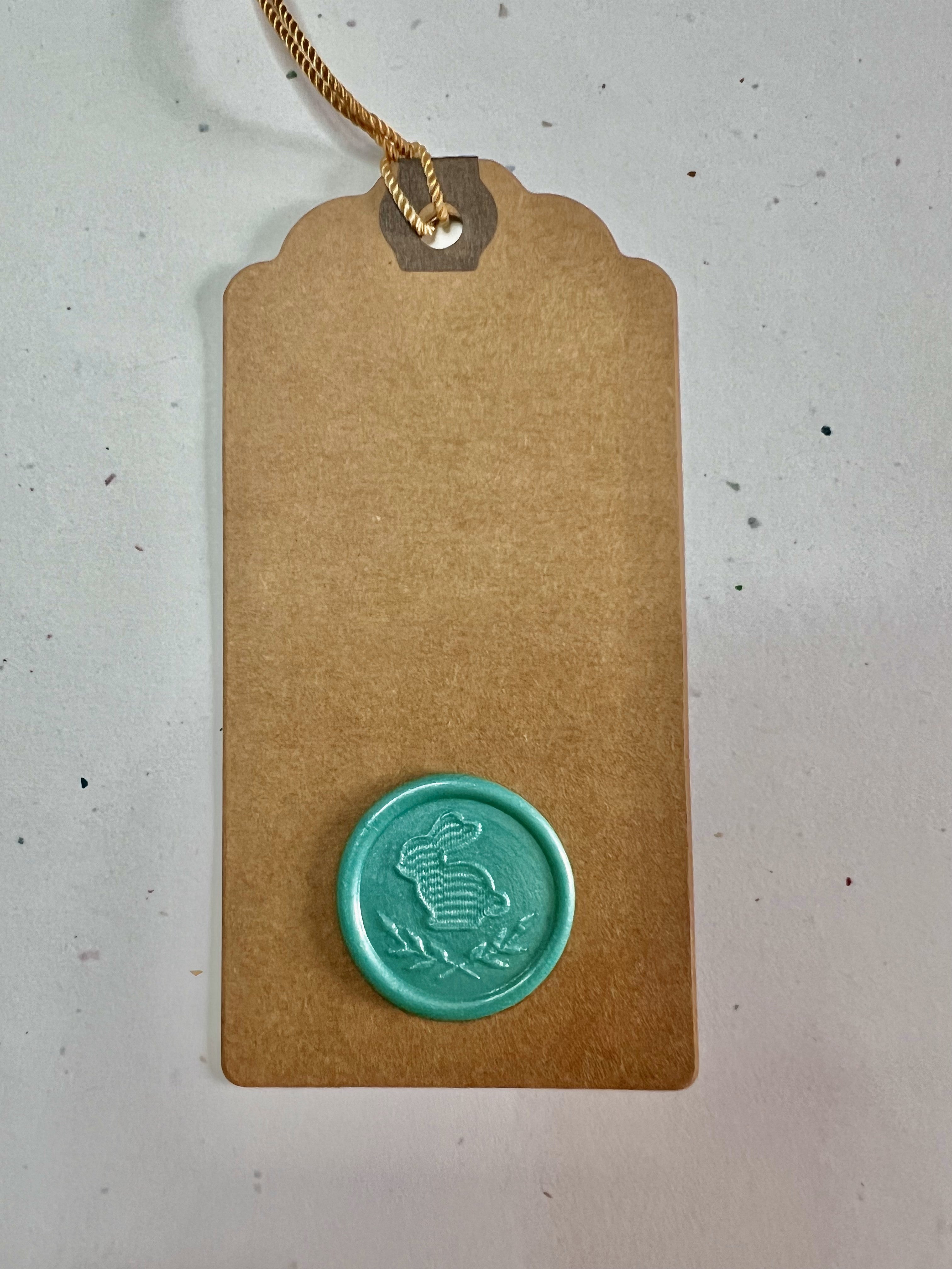 Kraft and satin-finish gift tags with pastel wax seals, designed for Easter baskets and cards.