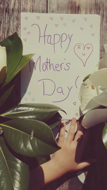 View of magnolia leaves with handwritten Happy Mother's Day card