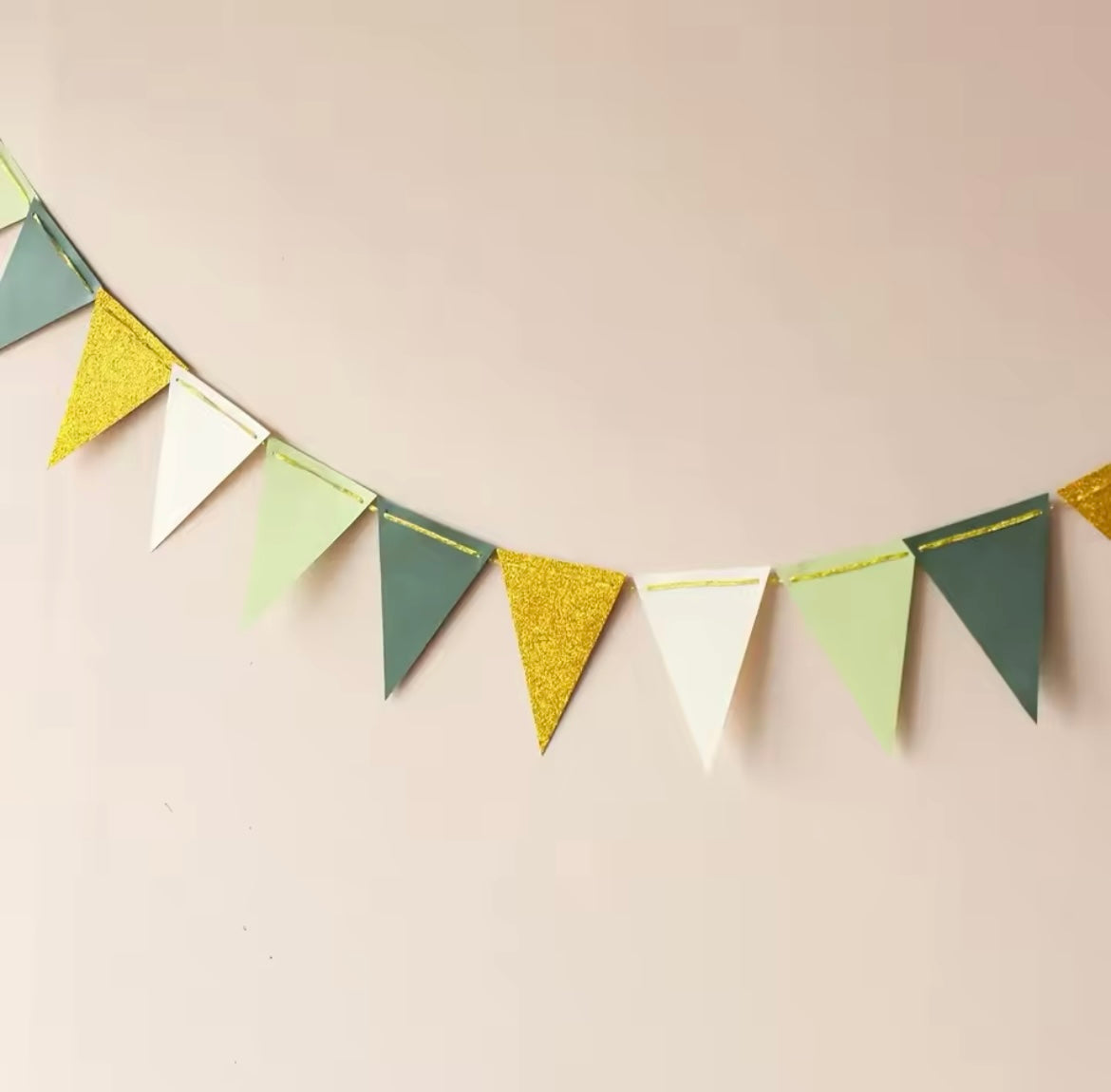 Banner displayed at a wedding shower with greenery accents