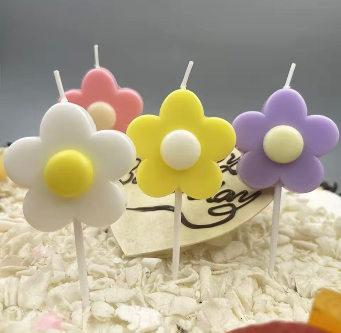 Set of five colorful daisy flower candles in bright party hues