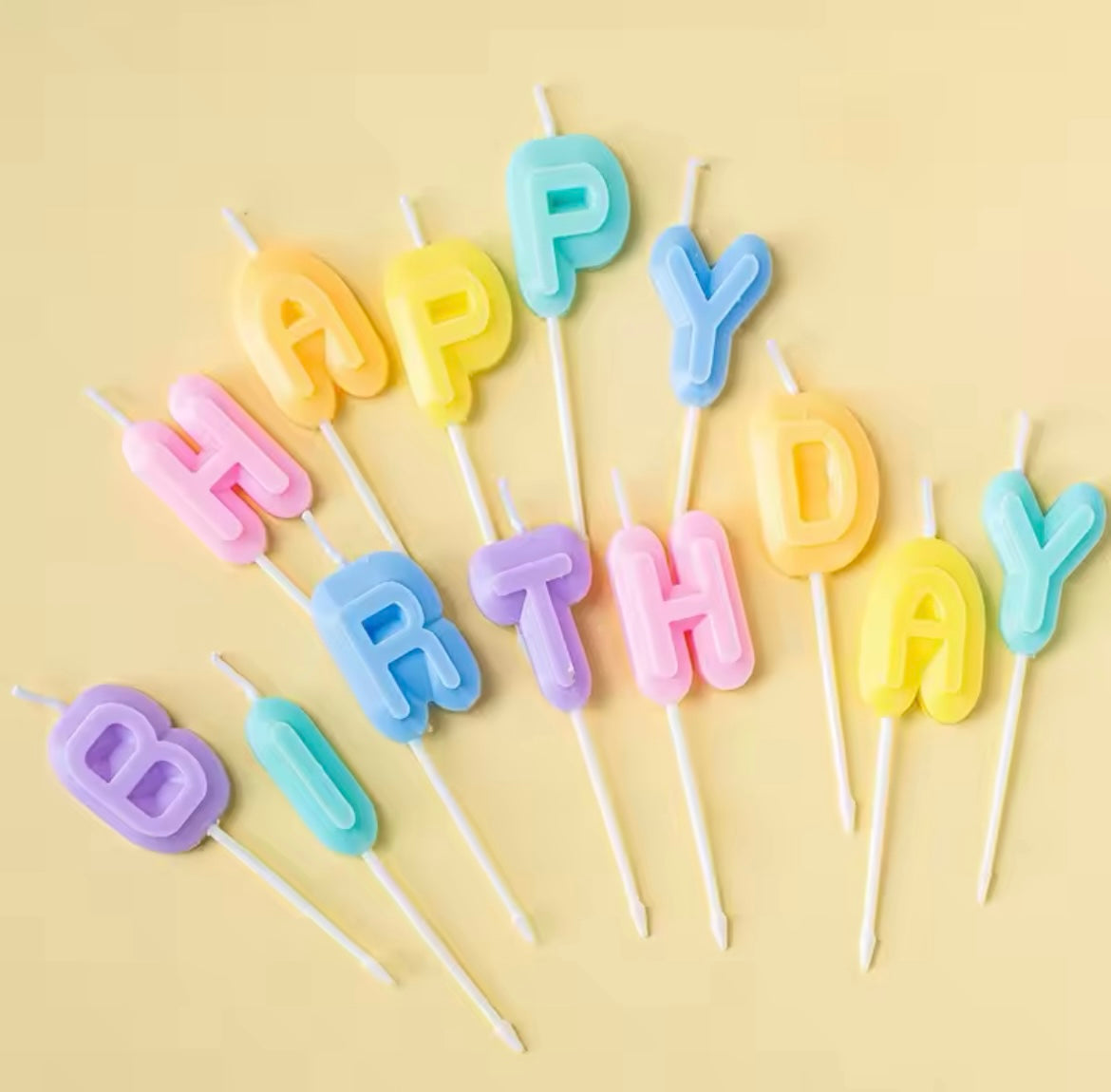 Set of pastel gradient “HAPPY BIRTHDAY” letter candles in bubble font