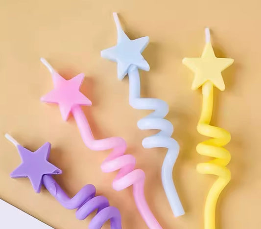 Set of four swirl star birthday candles in pastel gradient hues